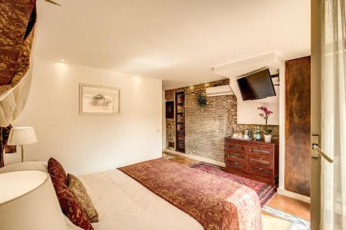 a hotel room with a bed and a television at Pantheonview - Luxury Suites in Rome