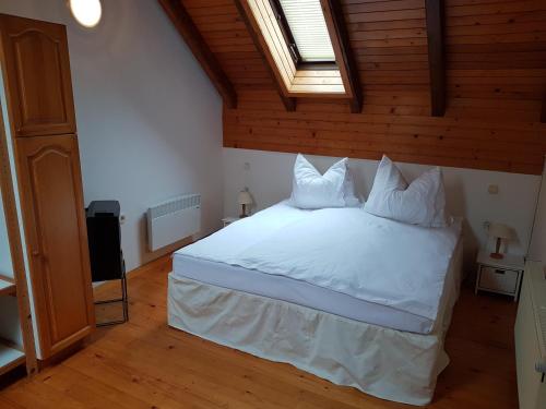 a bedroom with a bed with white sheets and pillows at Pr'Simi in Golnik
