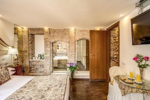 a large room with a stone wall and a bathroom at Pantheonview - Luxury Suites in Rome
