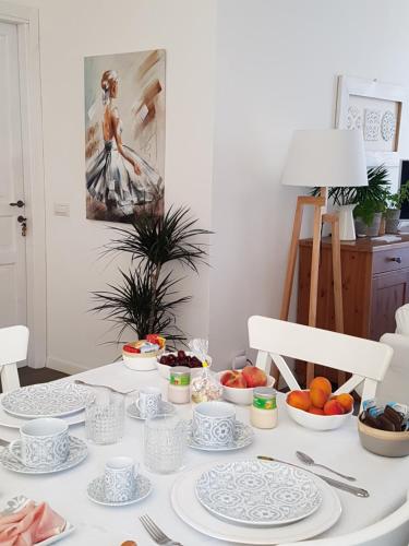 a table with plates and bowls of fruit on it at Azzurro B&B in Cefalù
