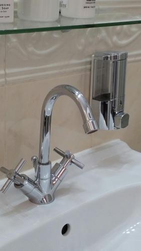 a bathroom sink with a silver faucet on it at Madge House Ashbourne in Ashbourne