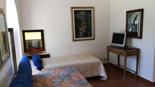 ミラッツォにあるPiccolo Casaleのベッド2台とテレビが備わる小さな客室です。