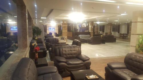 a salon with couches and chairs in a waiting room at Sea Club Resort in Dammam