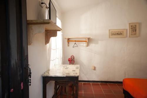 a room with a table in the corner of a room at HOTEL LA SELVA Reserva in La Vega