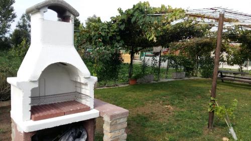 a white brick oven in a yard with a garden at Casa Vacanze Riviera del Brenta in Dolo