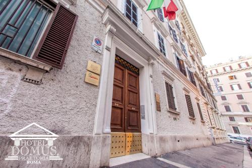 a building with a brown door on a street at Hotel Domus Praetoria in Rome