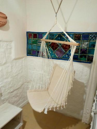 a white hammock in a room with a window at La Casa Di Lo in Monopoli