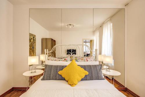 a bedroom with a bed with a yellow star on it at Elegant Apartment Behind the Colosseum in Rome
