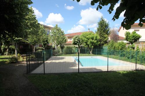 a fence around a swimming pool in a yard at Lespinet in Toulouse