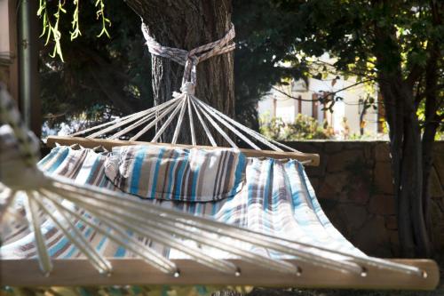 a hammock with blue and white pillows on it at Villa Jasmin in Koxaré