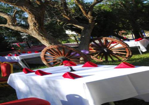 a group of tables with red napkins and a wagon at Dunhuang Hotel in Dunhuang