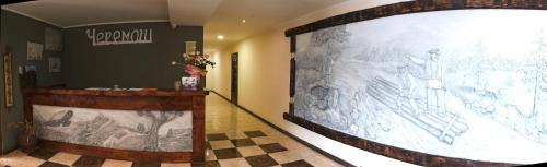a large projection screen in a room with a checkered floor at Cheremosh in Yablunytsya