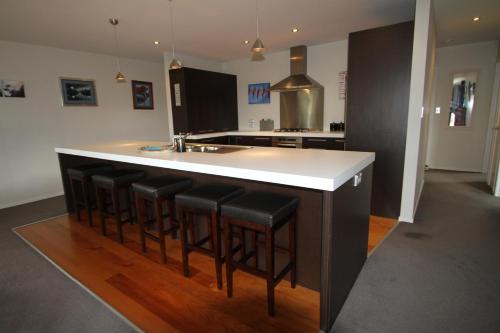 a kitchen with a island with bar stools at Ruapehu Retreat in National Park