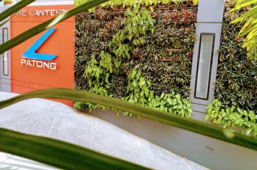 a retaining wall with plants on the side of a building at The Lantern Resorts Patong - SHA Extra Plus in Patong Beach