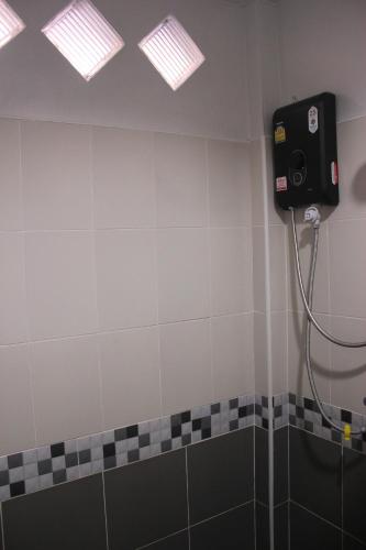 a bathroom with a shower with a speaker on the wall at Baan Phu Jad Kan in Uttaradit