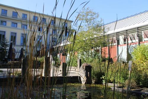 a building with a pond in front of a building at Castel de Pont-a-Lesse in Dinant