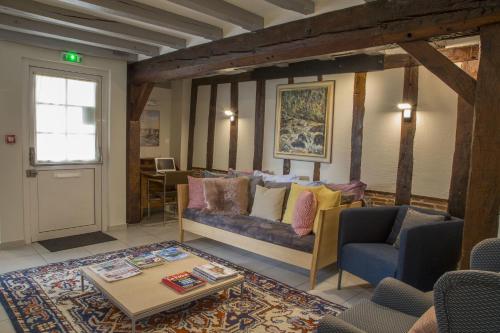 a living room with a couch and a table at Logis Hôtel Chaptal, Amboise in Amboise