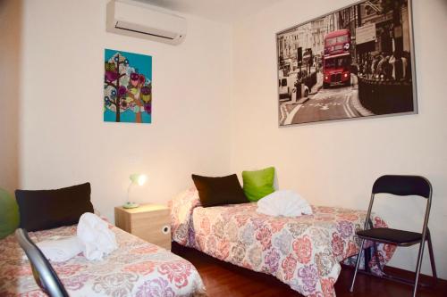 a bedroom with two beds and a red bus at Cuore di Roma Apartment in Rome