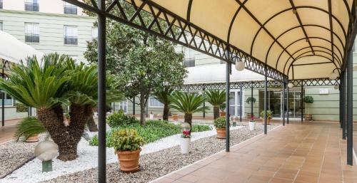 an indoor garden with plants in a building at Ilunion Alcora Sevilla in San Juan de Aznalfarache