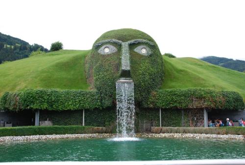 a water fountain in front of a hill with a bird head at Apartment Serlesblick in Ellbögen