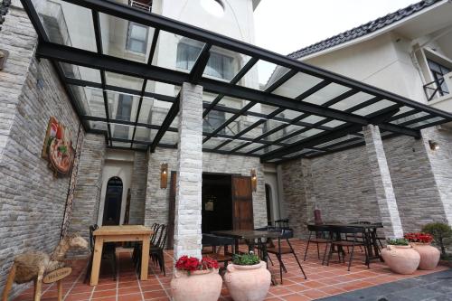 awning over a patio with tables and chairs at Black Chimney in Datong