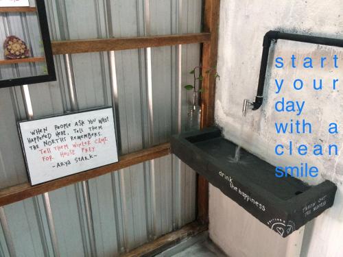 a bathroom with a sign that says start your day with a clean smile at Yez Yez Yez All Good Hostel in Yogyakarta