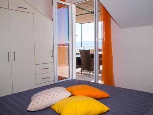 a bedroom with a bed with pillows on it at Apartmani Robert in Bol