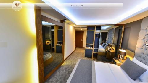 a hotel room with a bed and a bathroom at New Gate Hotel in Ankara