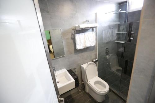 a bathroom with a toilet and a sink and a shower at Pantai Regal Hotel in Kuantan