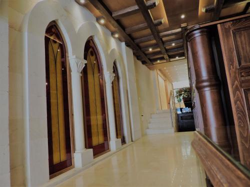 an empty hallway of a building with a staircase at La Place Hotel in Zahlé