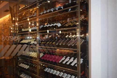 a display case filled with lots of wine bottles at Apartamentos VIDA Mar de Laxe in Laxe