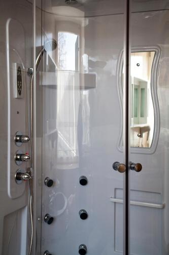 a shower with a glass door in a bathroom at Agritur Scoiattolo in Coredo