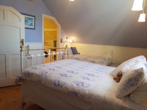 a bedroom with two beds with blue and white sheets at Water Bay Villa Bed & Breakfast in Adelaide