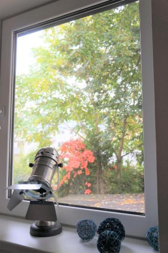 a camera in front of a window with a tree at Atelier Lomani in Vienna