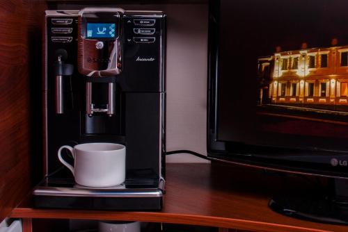 a coffee machine sitting next to a microwave at Ekaterinoslav in Dnipro