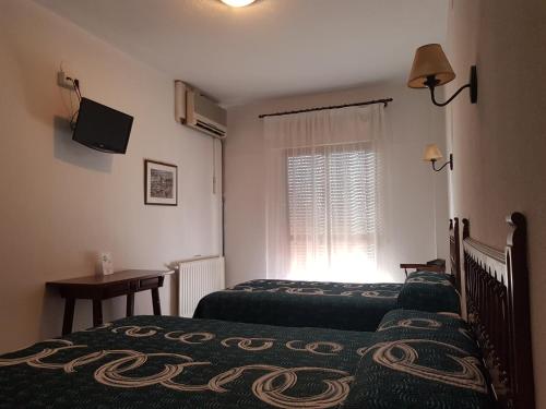 Tempat tidur dalam kamar di Hotel La Noria