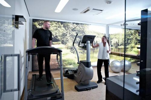 a man and a woman standing in a gym at Hotel Kaiserhof in Münster
