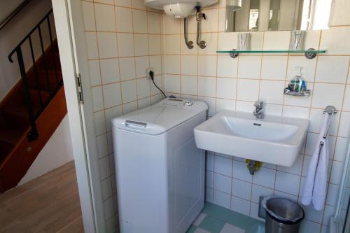 a bathroom with a toilet and a sink at Bargujac Summer House in Vis