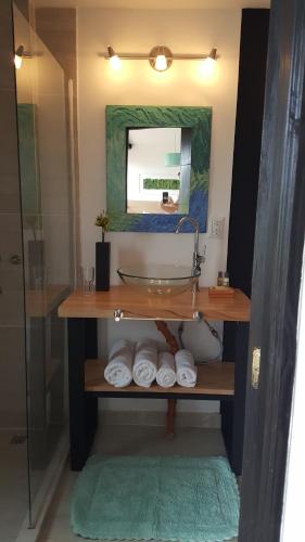 a bathroom with a sink and a mirror and towels at Amatxi in Los Reartes