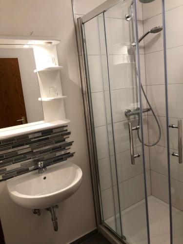 a bathroom with a sink and a shower at Hotel zum Kreidesee, kein Urlaubshotel ! in Hemmoor