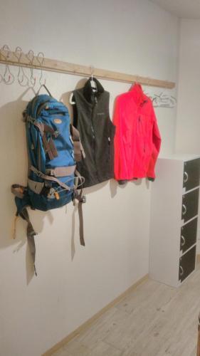 a shelf with a backpack and clothes on it at Asahikawa Ride in Asahikawa