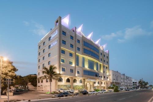 a building on the side of a street at Konoz Al Yam Hotel Jeddah in Jeddah