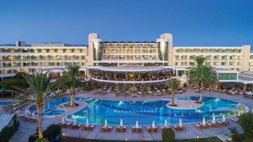 an aerial view of a resort with a large pool at Constantinou Bros Athena Beach Hotel in Paphos