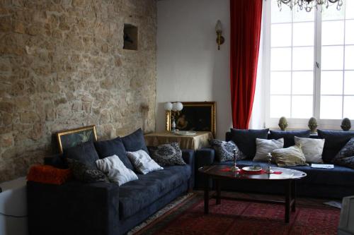 a living room with a blue couch and a table at Terra Mirna in Vižinada