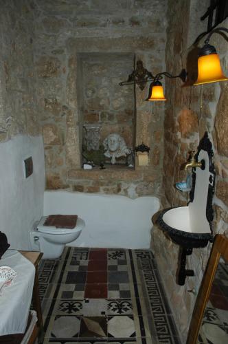 a bathroom with a tub and a toilet and a sink at Terra Mirna in Vižinada