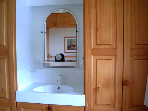 a bathroom with a sink and a mirror at bel-air 21 u.23 in Bellwald