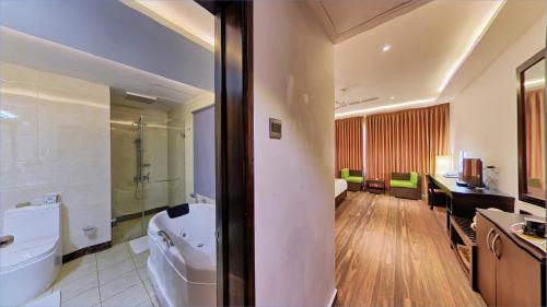 a bathroom with a sink and a toilet in a room at Cassandra Culture Resort in Sigiriya