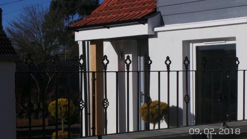 a fence in front of a white house at The Smithy in Largoward