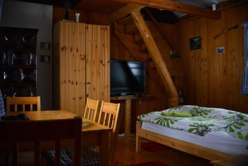 a bedroom with a bed and a tv and a table at Guest House Lagotto's Peak in Radatovići