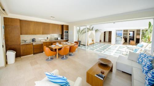 a living room with a couch and a table at Luxury Bay View Villa 28 Right On The Beach in Protaras